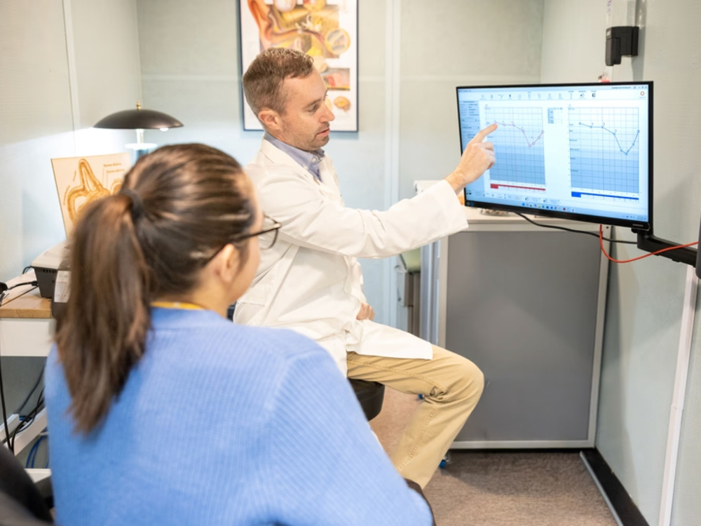Doctor of Audiology consulting with a patient at Precision Hearing in northwest San Antonio, TX