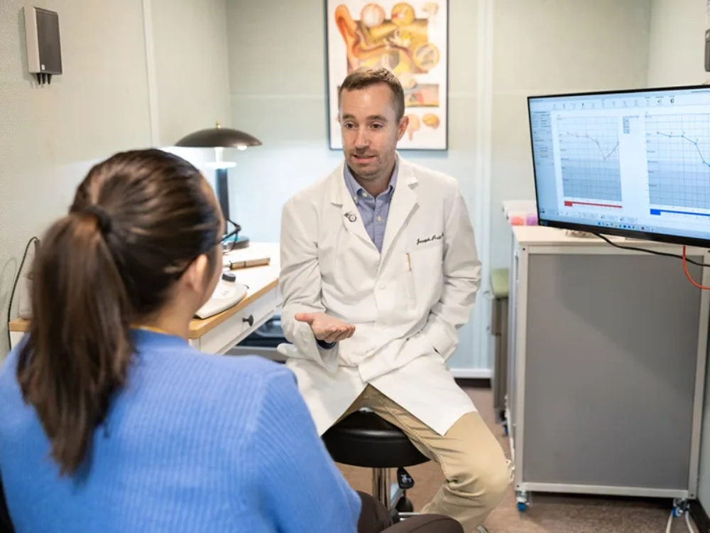 Doctor of Audiology reviewing an audiogram with a patient at Precision Hearing on Babcock Rd in San Antonio, TX