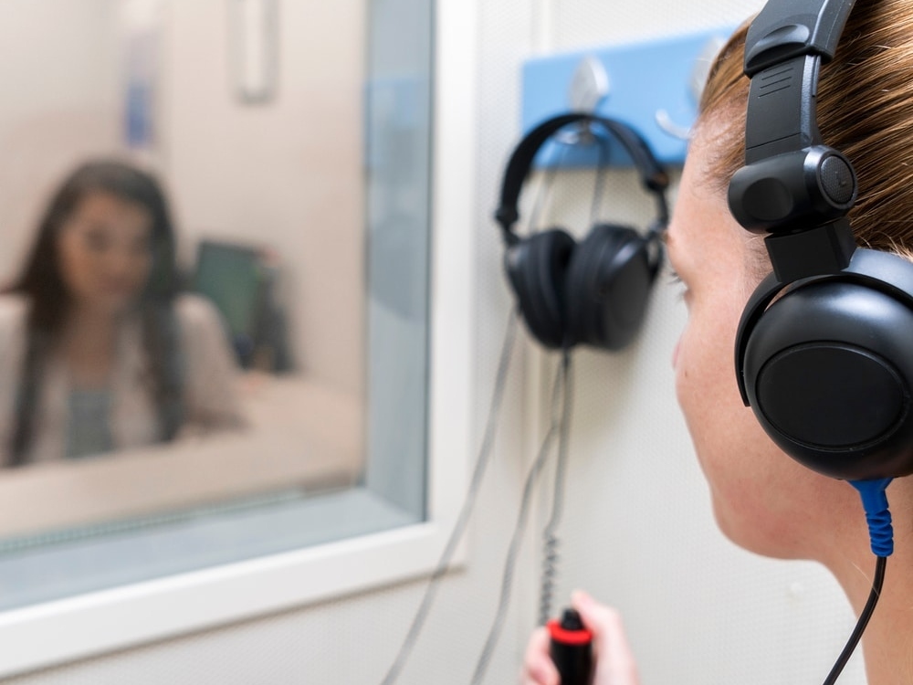 Doctor of Audiology conducting a comprehensive hearing evaluation with a patient at Precision Hearing in San Antonio, TX
