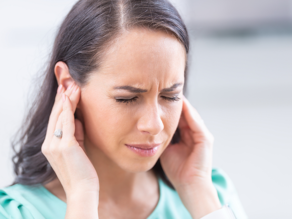 Doctor of Audiology evaluating a patient for tinnitus and ringing in the ears at Precision Hearing in San Antonio, TX